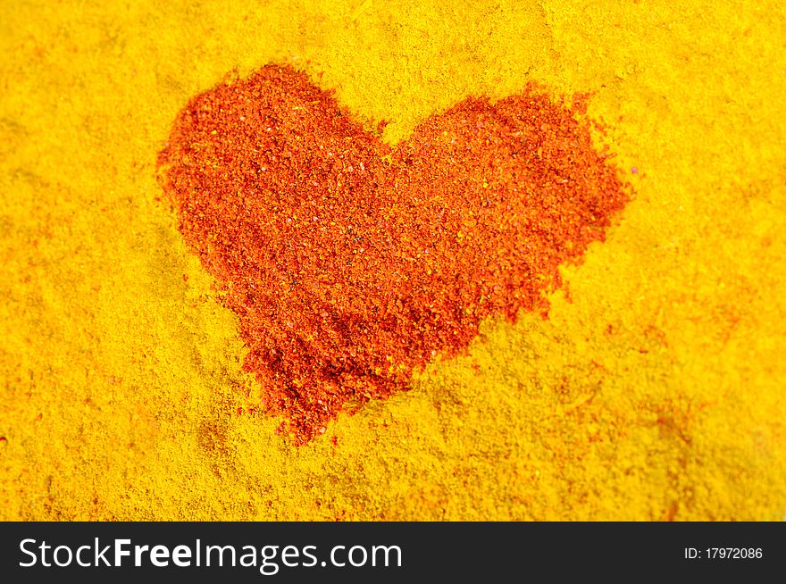 Red heart on a yellow background from spices. Red heart on a yellow background from spices
