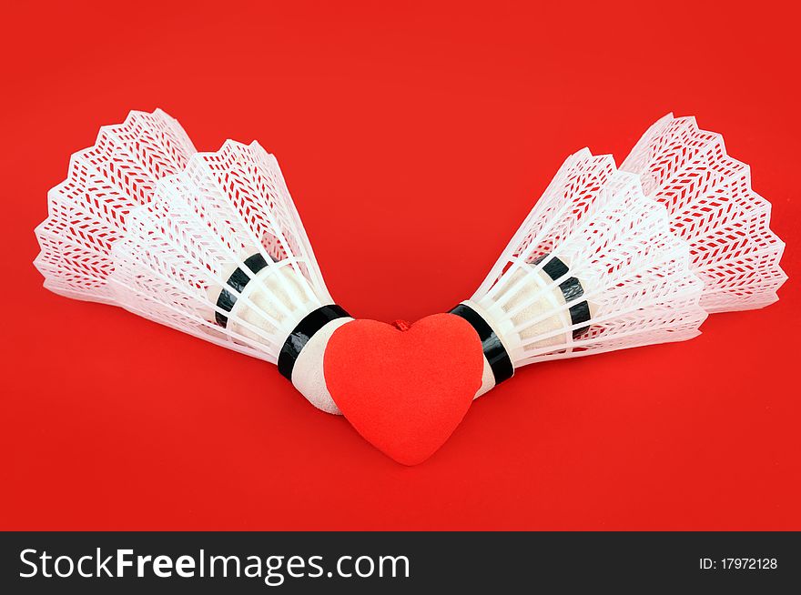 Four flounces for game in badminton on a red background. Four flounces for game in badminton on a red background