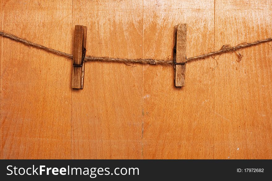 Pins on rope, wooden background