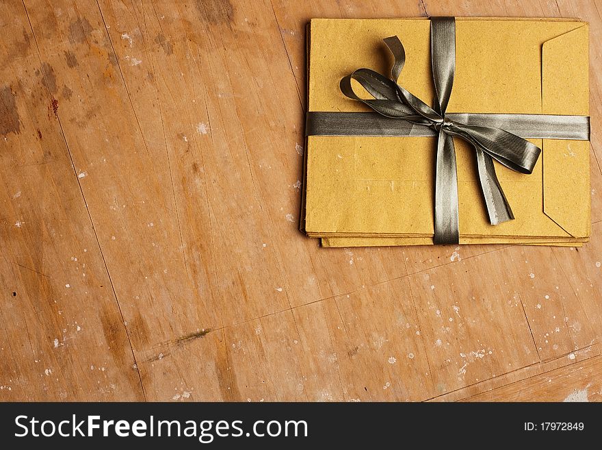 Vintage envelopes with a bow on a wooden background