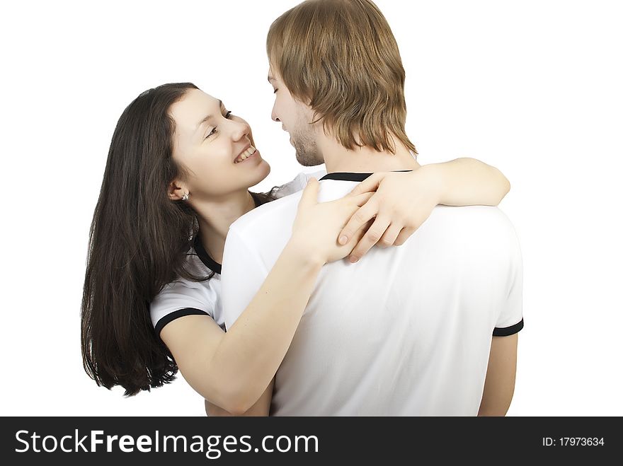 Beautiful young girl hugging her young man on a white background. Beautiful young girl hugging her young man on a white background