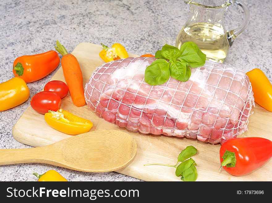 Roast pork before its preparation. With various vegetables and spices.