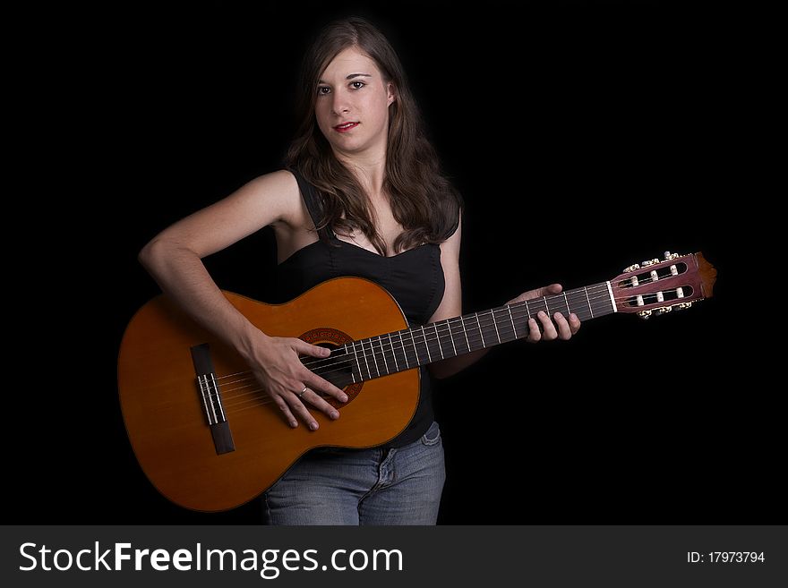 A young girl playing a classical guitar. A young girl playing a classical guitar