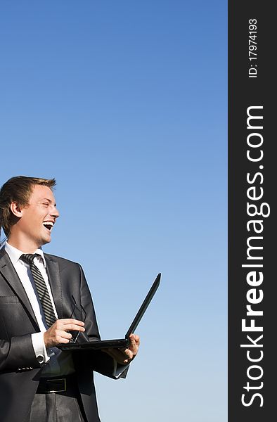 Businessman working with a laptop outdoor. Businessman working with a laptop outdoor