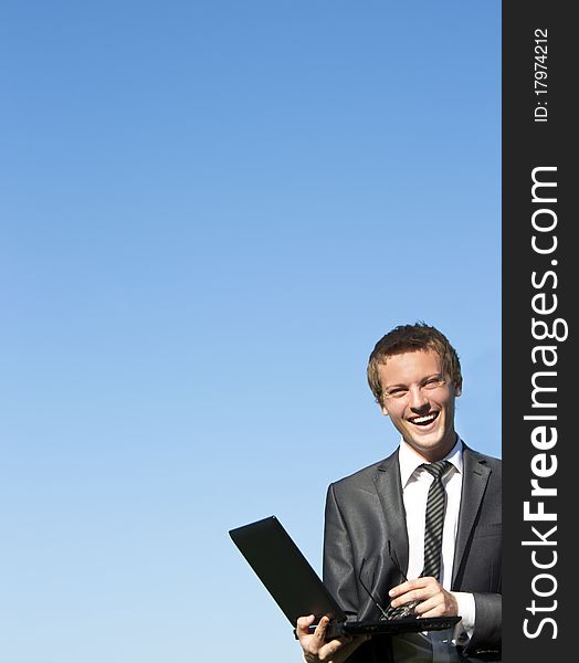Businessman working with a laptop outdoor. Businessman working with a laptop outdoor