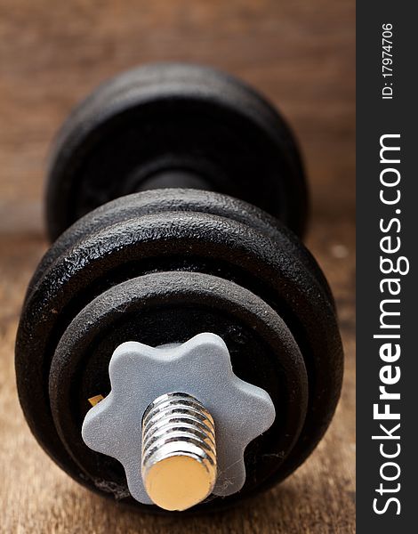 Dumbbell on a wood background