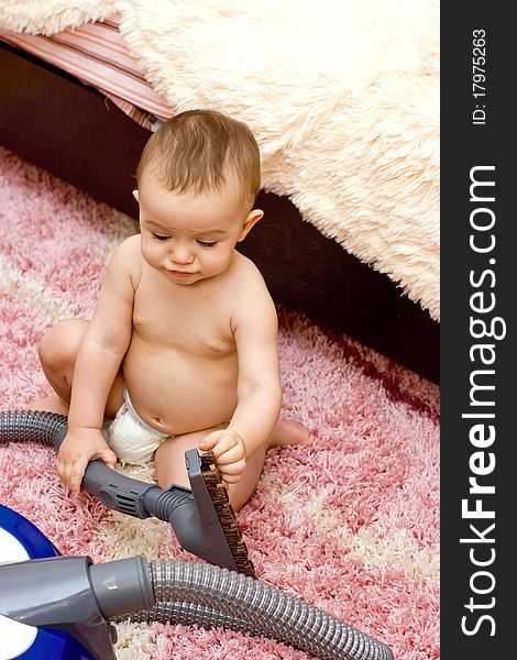 Cute Caucasian Baby With Vacuum Cleaner