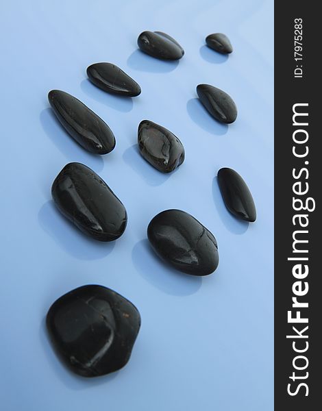 Spa stones on the blue background