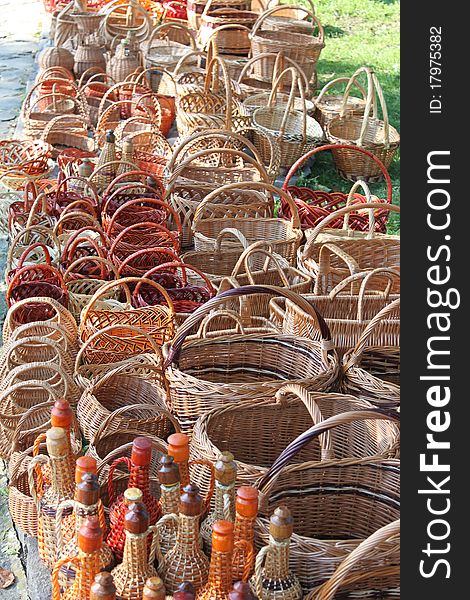 Baskets made from wicker, handmade crafts, arts and crafts, rural labor, the product at the festival, shop in the open air, retro profession, products of the vine, wine bottles overgrown with vines, retro technologyes, modern art