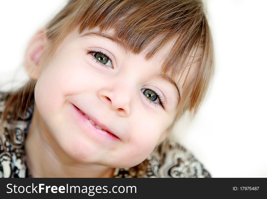 A beautiful 3 year old little girl smiling at the camera with her hed tilted. A beautiful 3 year old little girl smiling at the camera with her hed tilted