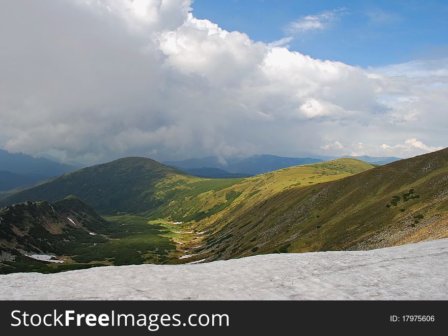 Spring on a hillside in a landscape under clouds. Spring on a hillside in a landscape under clouds