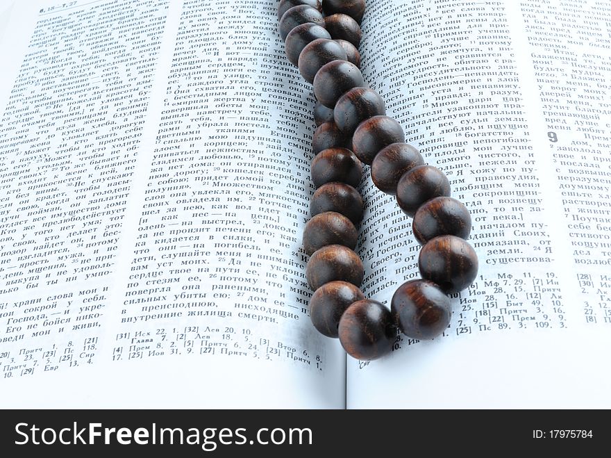 Bible open overhand lies wooden rosary beads. Bible open overhand lies wooden rosary beads