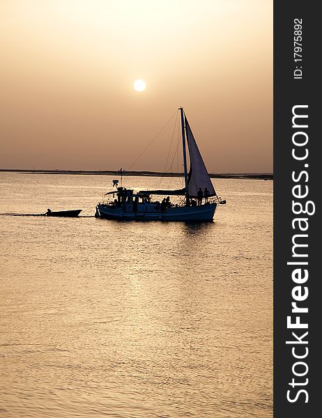 Recreation boat at sunset, in Ria Formosa, natural conservation region in Algarve, Portugal. Recreation boat at sunset, in Ria Formosa, natural conservation region in Algarve, Portugal.