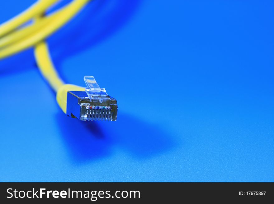 Yellow network cable on a blue background