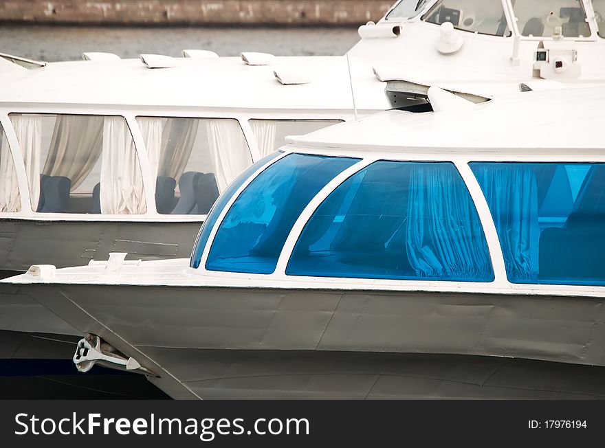 Two river vessels, one with transparent windows and the other with blue. Two river vessels, one with transparent windows and the other with blue