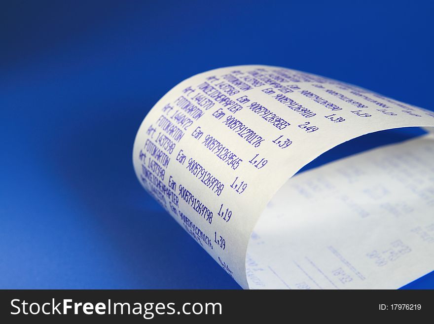 Desktop calculator paper roll, on blue background