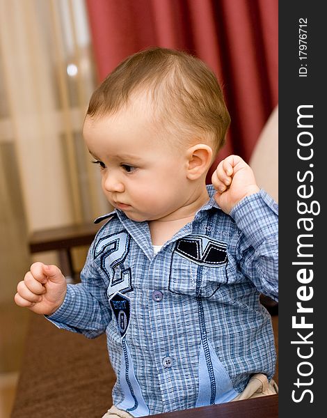 Cute caucasian baby in blue shirt