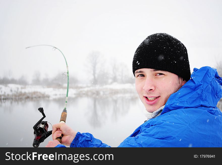 Portrait of an excited man fishing in winter time. Portrait of an excited man fishing in winter time