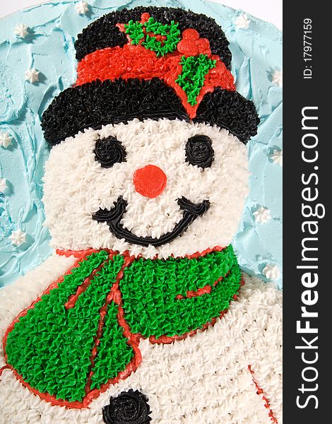 A buttercreme-decorated snowman on a white background. A buttercreme-decorated snowman on a white background.