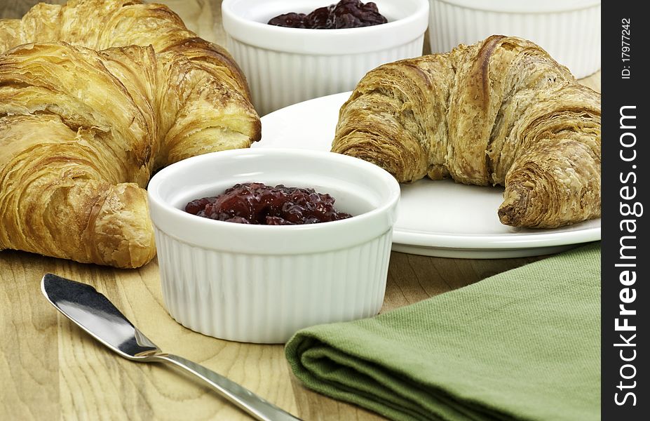 Fresh baked croissants and fruit jam. Fresh baked croissants and fruit jam