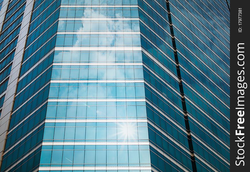 Glass Of Modern Buildings And Sky Reflect