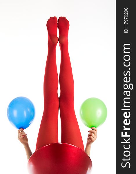 Female feet in red stockings with balloons isolated in white