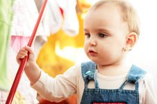 Cute Little Girl With Her Hand On A Red Stick Royalty Free Stock Photos