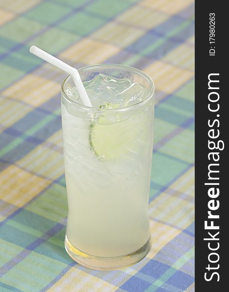 Tropical lemonade with sliced lime and white straw. Tropical lemonade with sliced lime and white straw