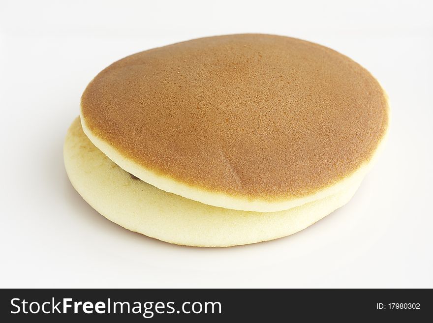 A pair of Japanese pancake stuffed with red bean or dorayaki. A pair of Japanese pancake stuffed with red bean or dorayaki