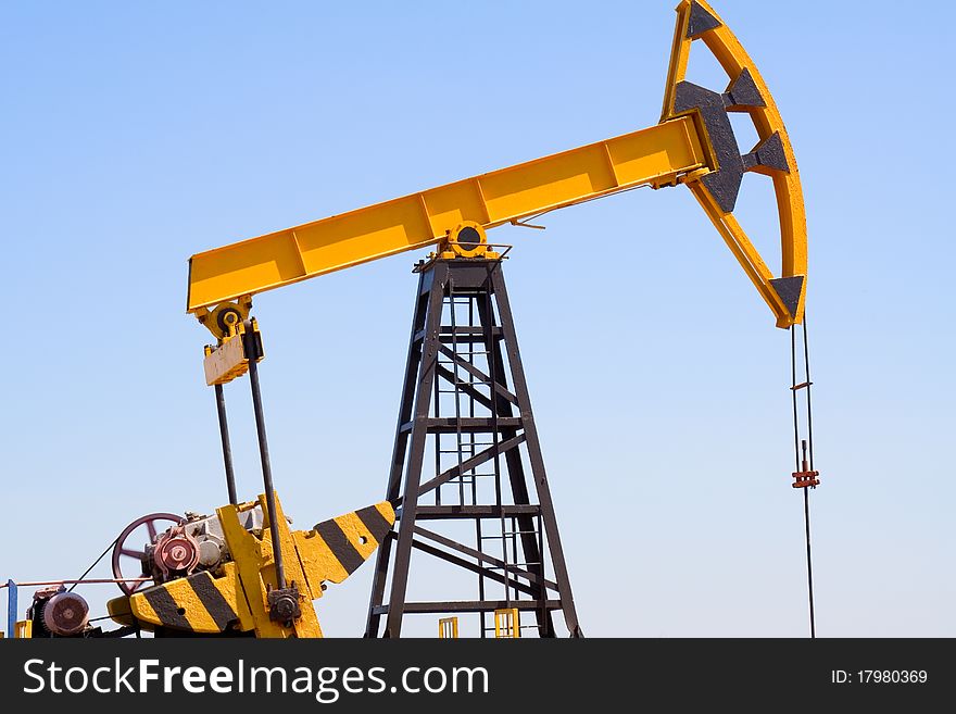 Close-up of oil pump jacks.A pumpjack against blue sky