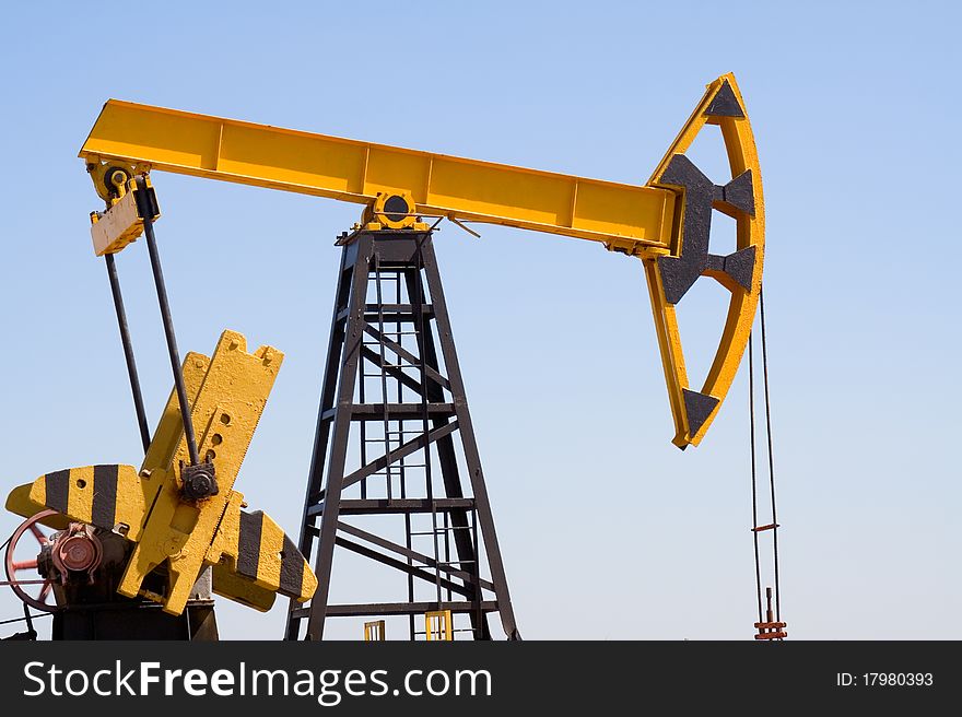 Close-up of oil pump jacks.A pumpjack against blue sky