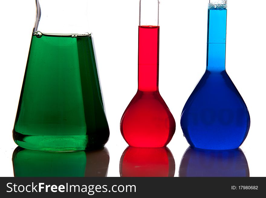 Labolatory glassware with colorful fluids isolated on white