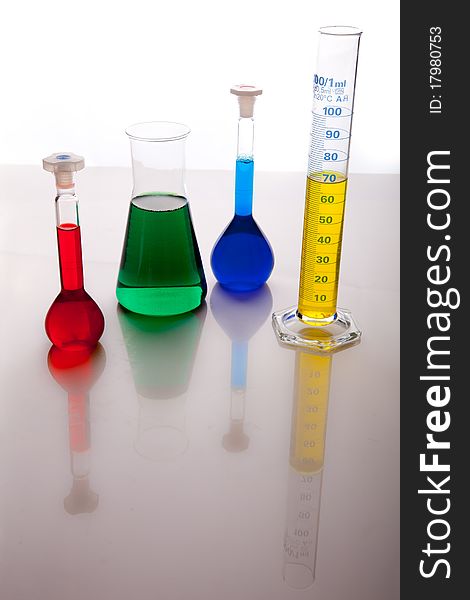 Labolatory glassware with colorful fluids isolated