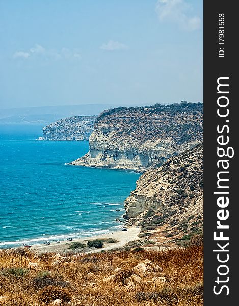 Kourion coast with blue sea and sky with clouds.