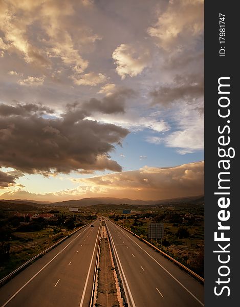 Beautiful dramatic cloudy sunset sky over highway. Beautiful dramatic cloudy sunset sky over highway