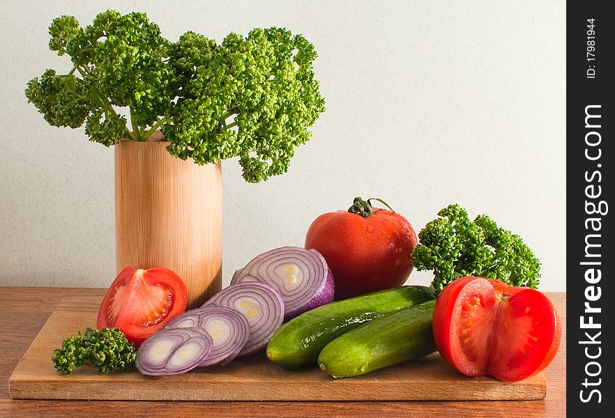 Still life of vegetables and herbs on a cutting board