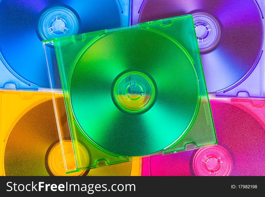 Computer disks in multiciolored boxes - technology background