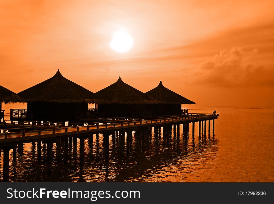 Water bungalows and sunset - abstract vacation background