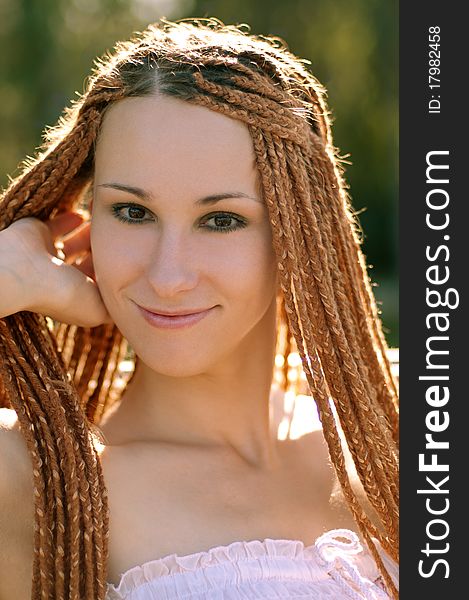 Beautiful girl with pigtails in the park summer morning. Beautiful girl with pigtails in the park summer morning