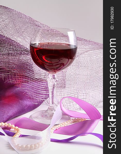 Glass with red wine on decorative background. Glass with red wine on decorative background