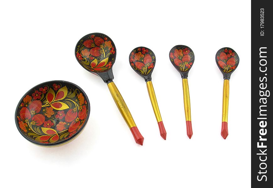 Painted wooden spoons and cup on a white background