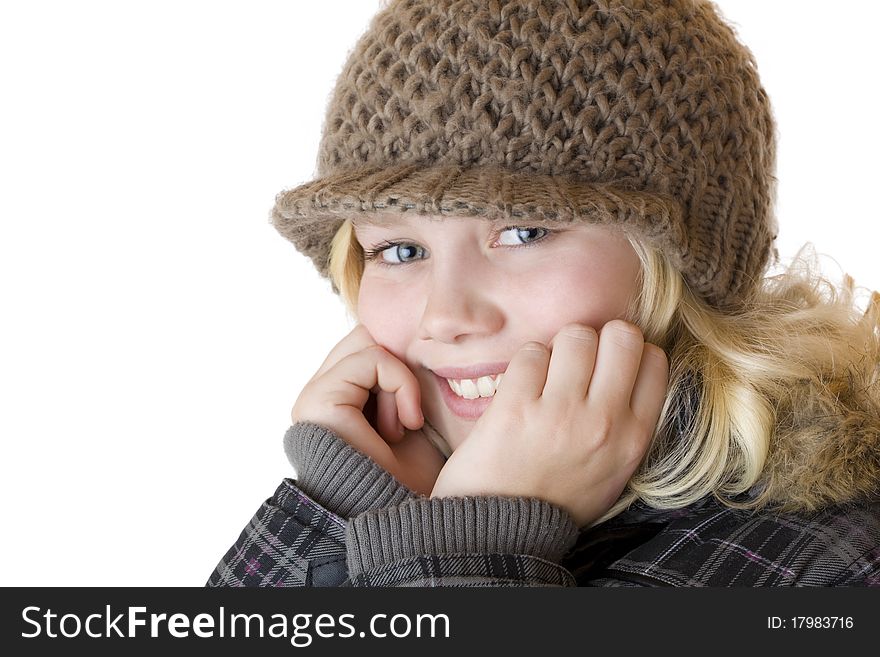 Young blond girl with winter cap and jacket. Isolated on white background.