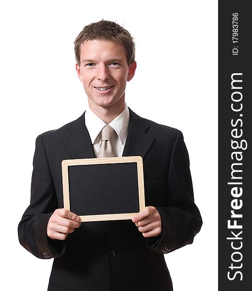 Young smiling businessman holding empty blackboard isolated on white background. Young smiling businessman holding empty blackboard isolated on white background