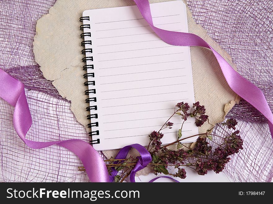 Background for notes with writing pad, ribbons and herbs