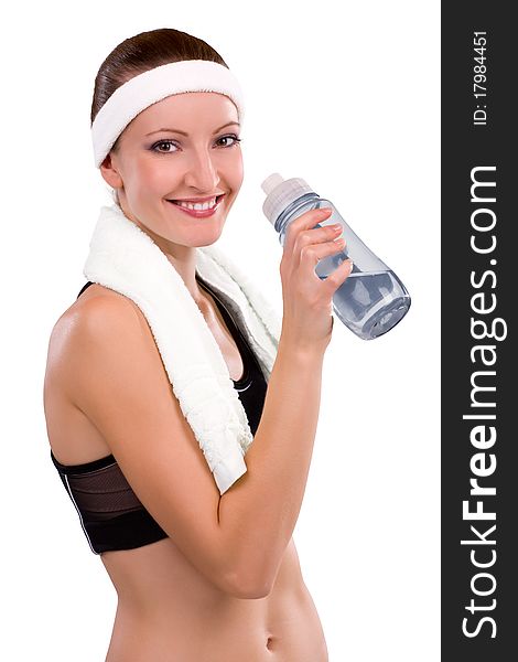 Beautiful young athlete with bottle of water and towel on her shoulders. Beautiful young athlete with bottle of water and towel on her shoulders