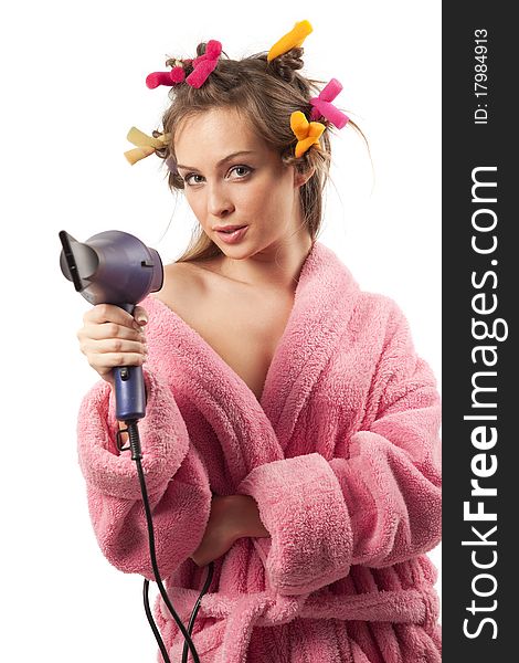 Shot of adult girl dressed pink dressing gown with blue hairdryer. Shot of adult girl dressed pink dressing gown with blue hairdryer