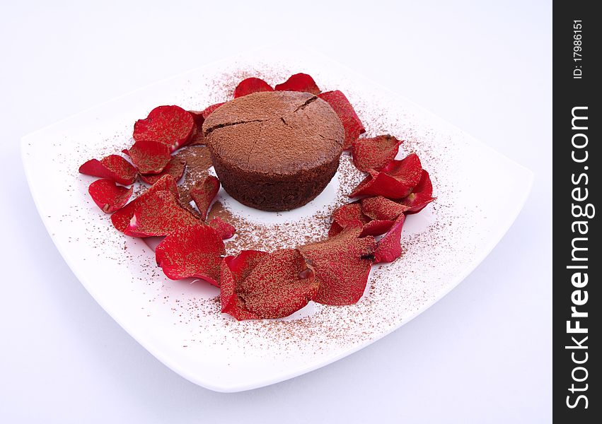 Chocolate soufflé decorated with red rose petals and cocoa powder. Chocolate soufflé decorated with red rose petals and cocoa powder