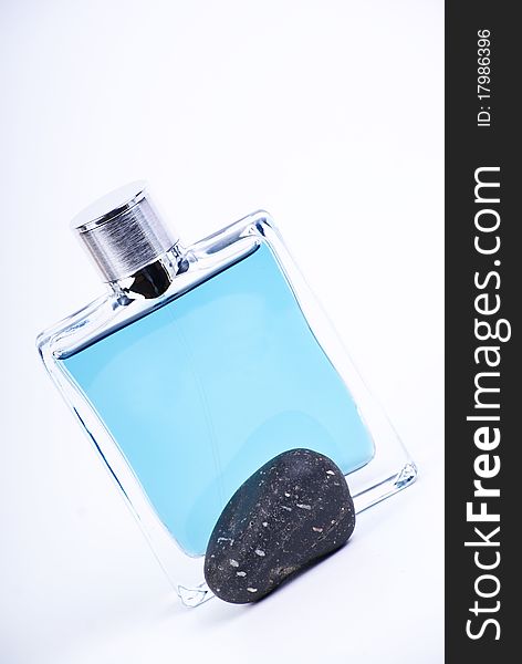 Blue parfume bottle and black stone