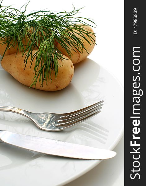 Potatoes and plate isolated over white background. Potatoes and plate isolated over white background.