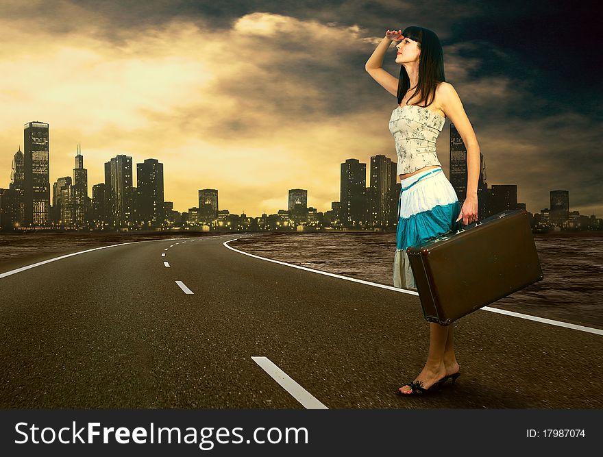 Young woman waiting on the road with her vintage baggage. Young woman waiting on the road with her vintage baggage